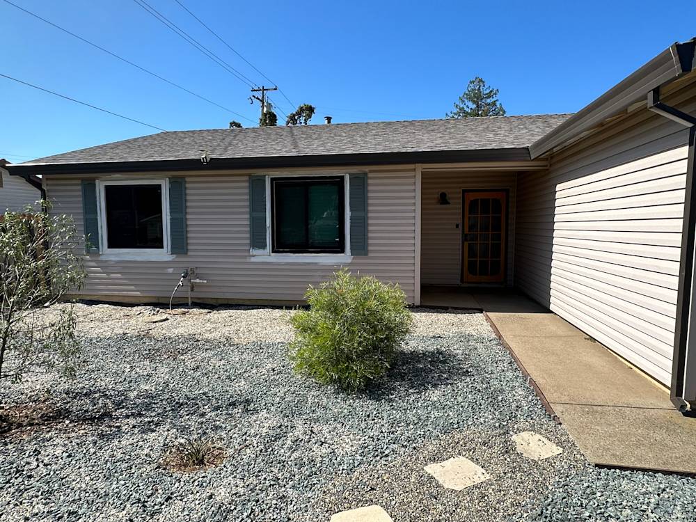 Single-story home exterior in Sacramento with a gravel landscape and light-colored siding