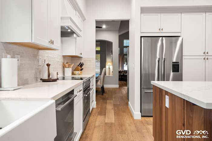 Modern kitchen remodel featuring Waypoint cabinets, Custom Vadara Bronzo countertops, and wood flooring in Folsom, CA