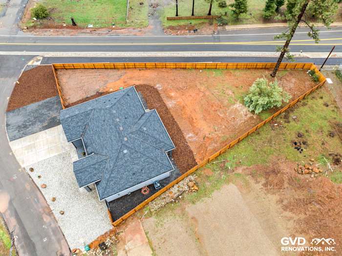Aerial view of a new home in Paradise, showcasing black Milgard windows and Sea Grass James Hardie siding