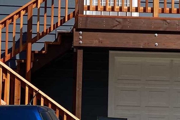 Home exterior in Rio Vista featuring CraneBoard vinyl siding, new Anlin windows, and a wooden deck with steps