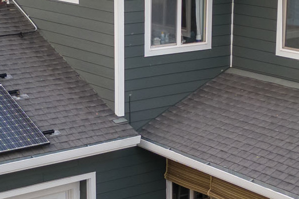Home exterior featuring James Hardie Pearl Gray siding, white trim, and solar panels on a roof in Campbell, CA