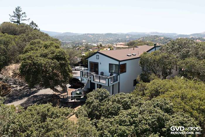Home exterior featuring Arctic White James Hardie Lap Siding, surrounded by lush greenery in San Rafael, CA