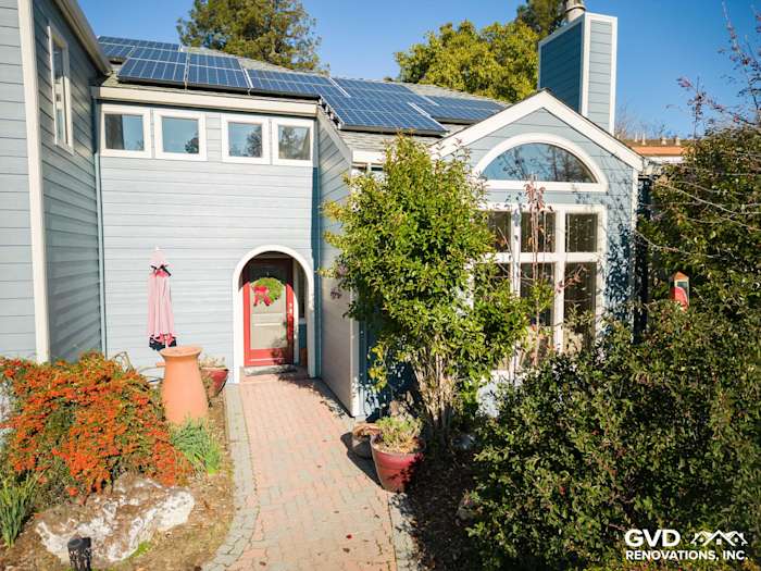 Home exterior featuring Boothbay Blue James Hardie siding, landscaped entrance, and solar panels in Davis, CA