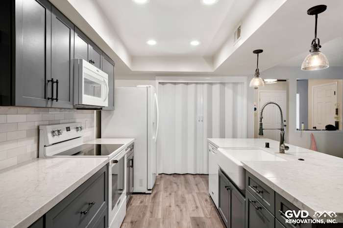 Modern kitchen remodel featuring gray cabinetry, quartz countertops, and stainless-steel appliances in Sacramento
