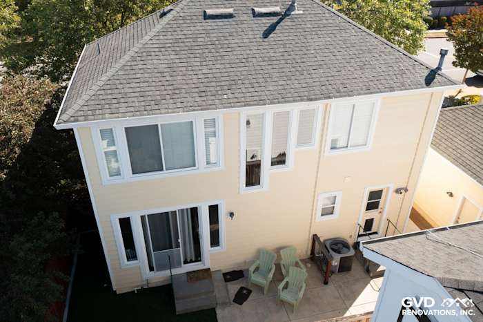 Two-story home exterior in Petaluma, featuring Prodigy insulated vinyl siding in soft yellow with a gray roof