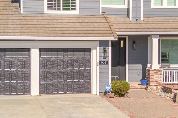 Home exterior featuring James Hardie Lap Siding in Night Gray with Arctic White trim, beautiful landscaping in San Jose