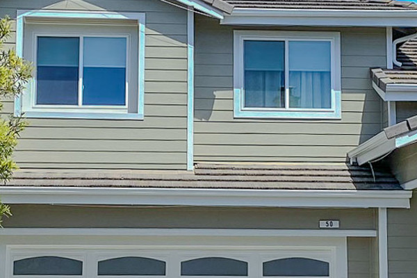 Richmond home with newly installed James Hardie Monterey Taupe siding and Anlin windows, enhanced curb appeal