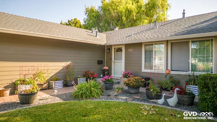 Home exterior featuring Timber Bark HardiePlank siding, Cobble Stone trim, and a colorful flower garden in Rohnert Park
