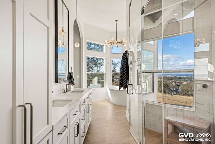 Elegant master bathroom with zero-threshold steam shower, freestanding tub, and custom tile work in El Dorado Hills