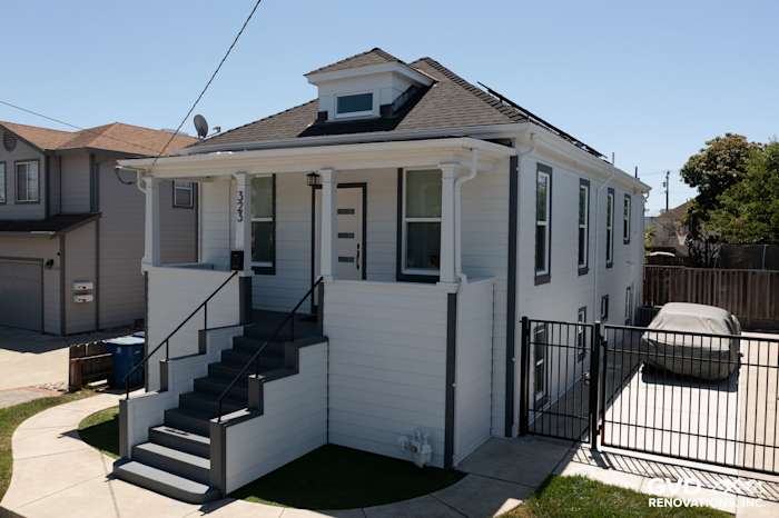 Arctic White James Hardie Color Plus lap siding on a San Leandro home with new trim and steps