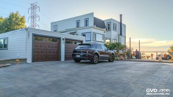 Modern home exterior featuring James Hardie Arctic White siding, Anlin Windows, and a stone paver driveway in Orinda, CA