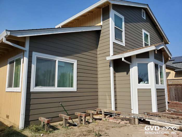 Newly installed James Hardie siding in two-tone gray and yellow on a Santa Rosa home exterior