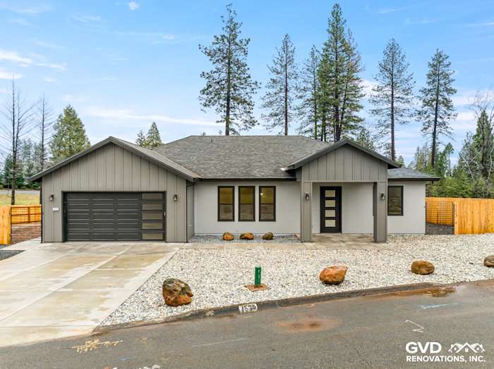 New construction home in Paradise, CA with James Hardie Architectural Panels, Milgard black windows, and gravel landscaping
