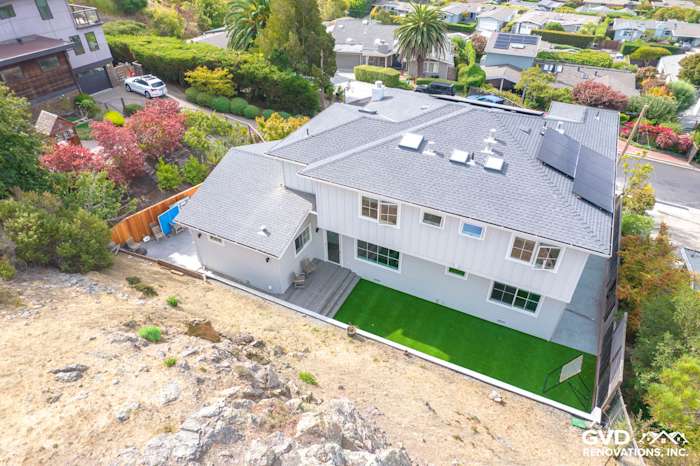 Aerial view of a home in Tiburon featuring newly installed James Hardie Artisan Lap Siding and green lawn