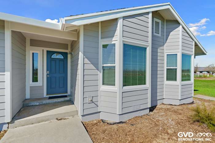 Front exterior of home with Pearl Gray James Hardie siding and Arctic White trim, featuring Anlin windows