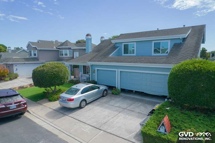 Transformed home exterior in Foster City with James Hardie siding, Alside windows, and landscaped driveway