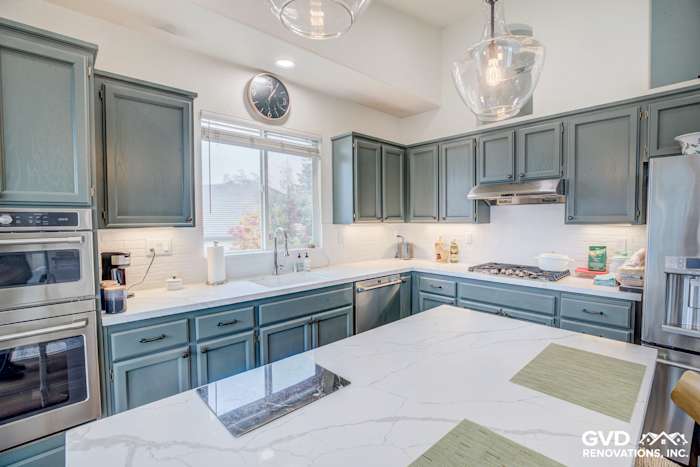 Modern El Dorado Hills kitchen remodel featuring dark green cabinets, white quartz countertops, and stainless steel