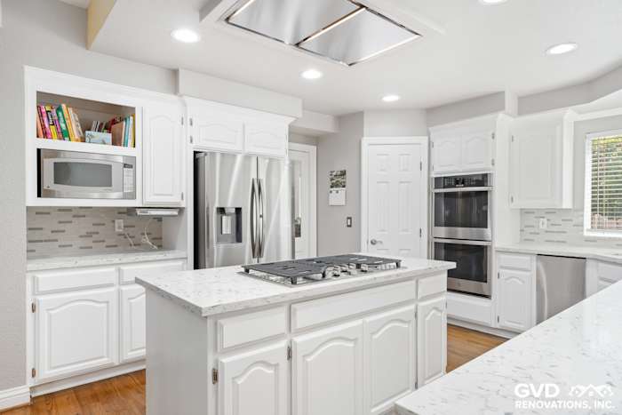 Bright Fair Oaks kitchen renovation featuring white cabinets, quartz countertops, and stainless steel appliances
