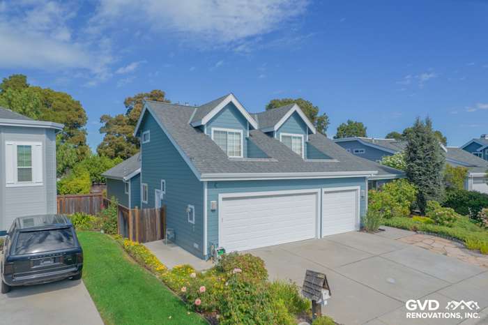 Home exterior featuring James Hardie siding in Boothbay Blue with Arctic White trim and a two-car garage in Foster City