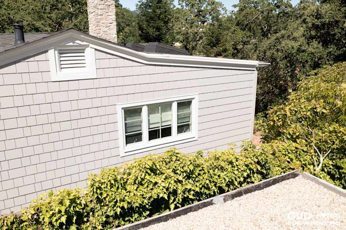 Pearl Gray James Hardie shingle siding on home exterior with green landscaping in Orinda, CA