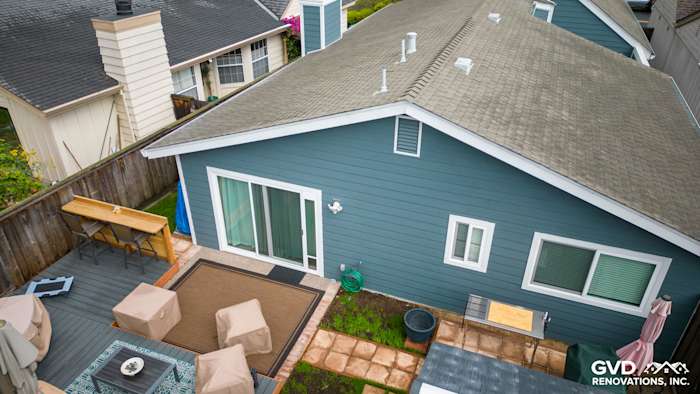Evening Blue James Hardie siding with Arctic White trim on a home in Alameda, CA, featuring a landscaped patio