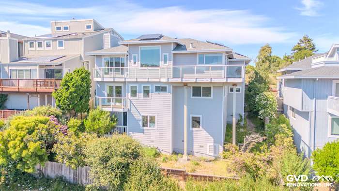 Modern home exterior featuring James Hardie Pearl Gray siding, Arctic White trim, and large Milgard windows in Mill Valley