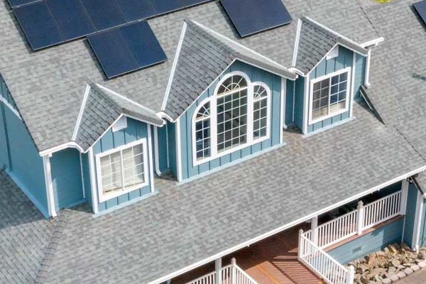Aerial view of a home in Shingle Springs with new blue James Hardie siding and solar panels