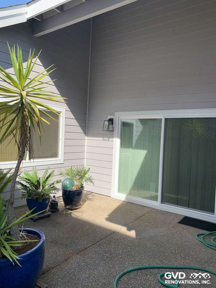 Pearl Gray James Hardie siding with Arctic White trim and large sliding glass door in Napa, CA backyard