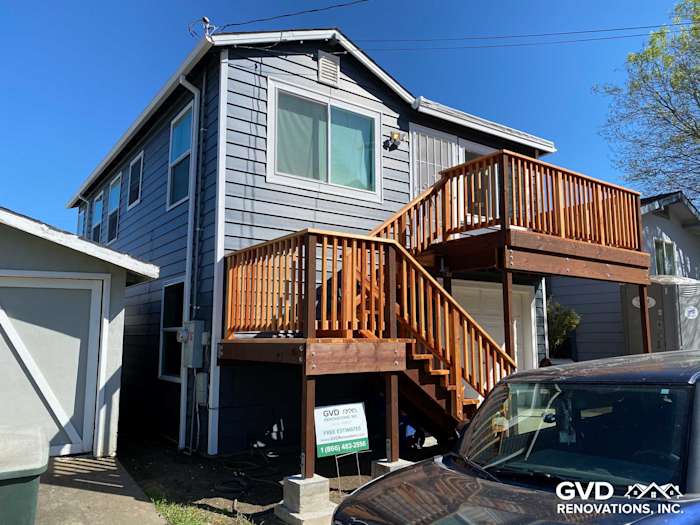 Updated home exterior featuring CraneBoard vinyl siding, Anlin windows, and new wooden deck in Rio Vista, CA