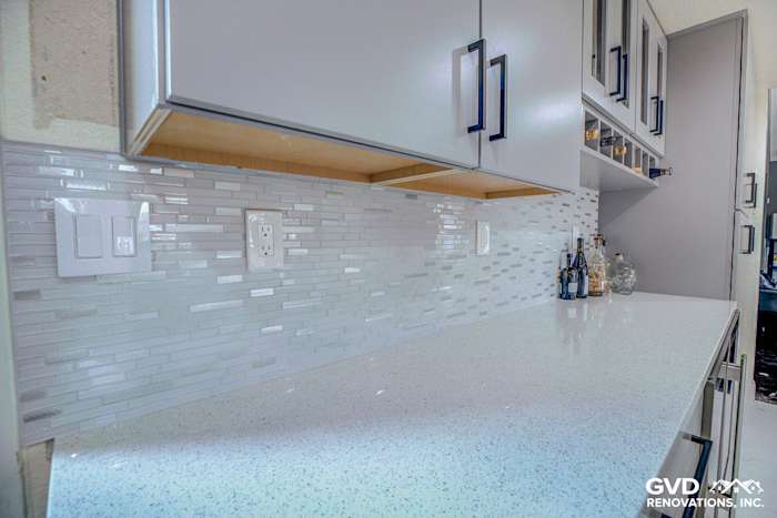 Quartz countertop with sleek gray subway tile backsplash and modern cabinetry in a Sacramento kitchen remodel