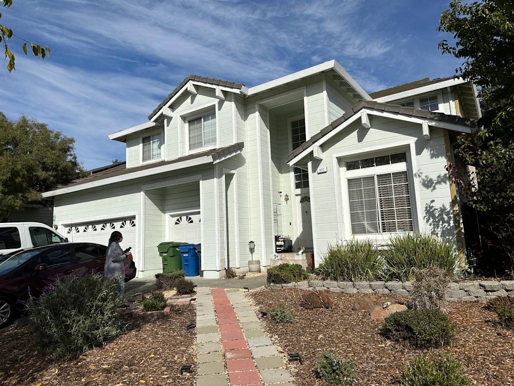 Light green house exterior with stone pathway and desert landscaping in Kensington, Sacramento area