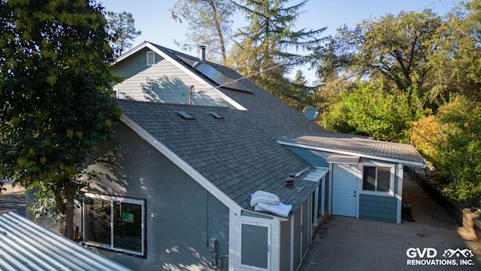 Home exterior in Colfax, CA, featuring Gray Slate James Hardie siding and Arctic White trim under clear blue skies