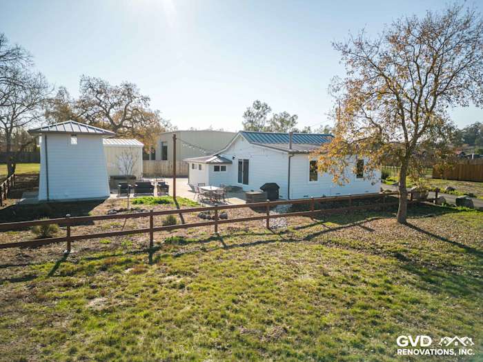 Arctic White James Hardie siding installed on a Sonoma home with surrounding greenery and fencing