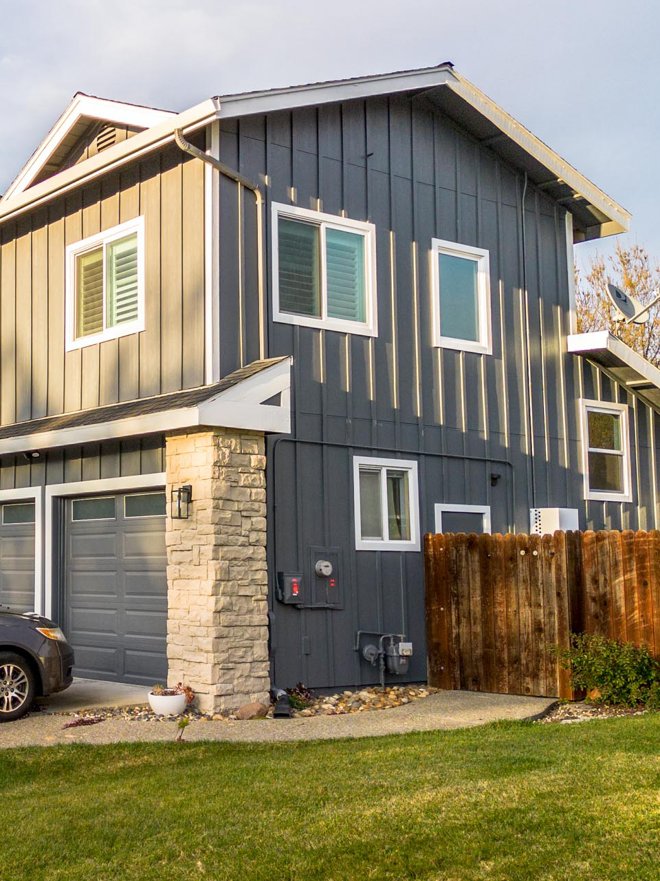 Modern gray siding with new stone accents and updated windows