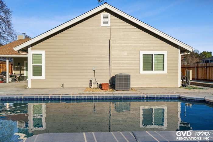 Monterey Taupe HardiePlank siding with Arctic White trim on a Folsom home overlooking a pool