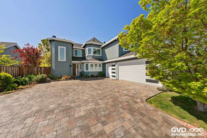 Boothbay Blue HardiePlank siding and Arctic White trim adorn a Foster City home exterior with a stone driveway