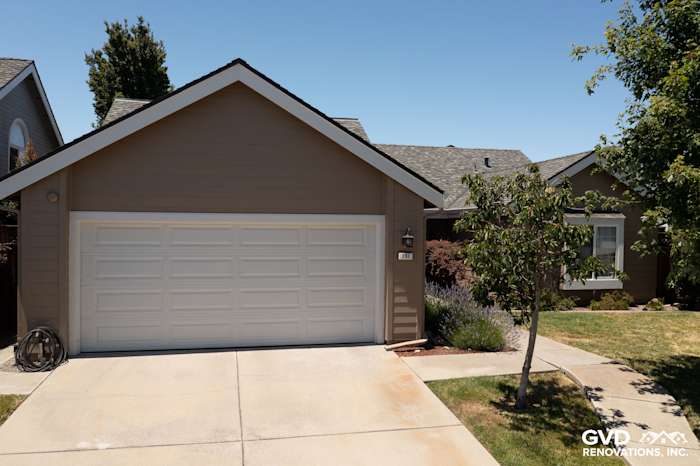 Home exterior featuring James Hardie Artisan Lap Siding in Khaki Brown with Arctic White trim and Simonton windows