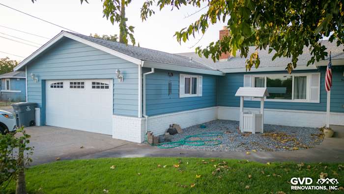 Newly installed light blue Alside Prodigy vinyl siding on home exterior in Yuba City, featuring white brick accents