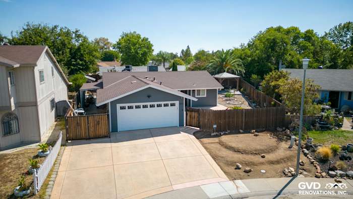 Sacramento home exterior featuring James Hardie Night Gray siding and Arctic White trim, surrounded by landscaping
