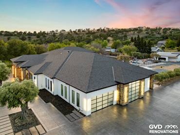 Modern home exterior with premium black roofing, stone accents, and lush landscape in Northern California evening light