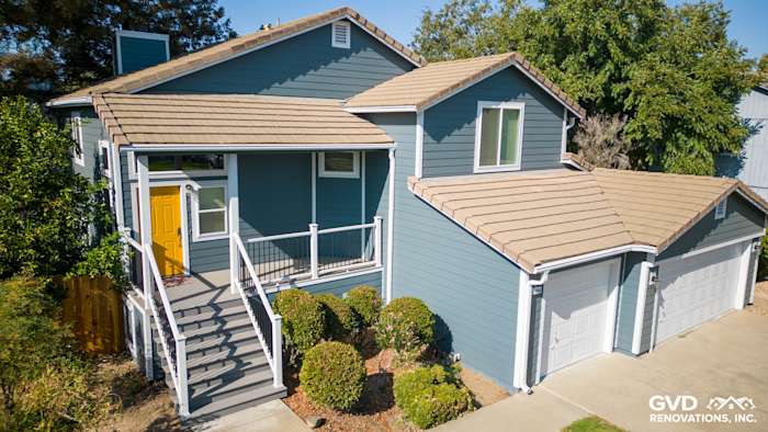 Updated home exterior in Dixon, CA with blue siding, new Anlin windows, and a refreshed deck with side steps