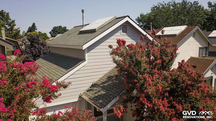 Pearl Gray HardiePlank Lap Siding with Arctic White trim on a Davis, CA home surrounded by flowering trees
