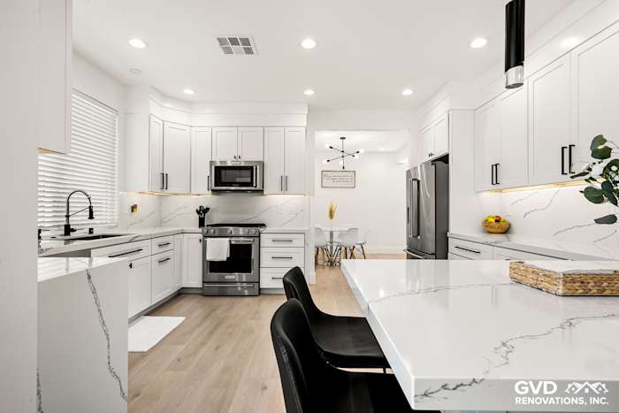Modern kitchen remodel in Antelope with quartz countertops, custom cabinets, stainless steel appliances, and stylish lighting
