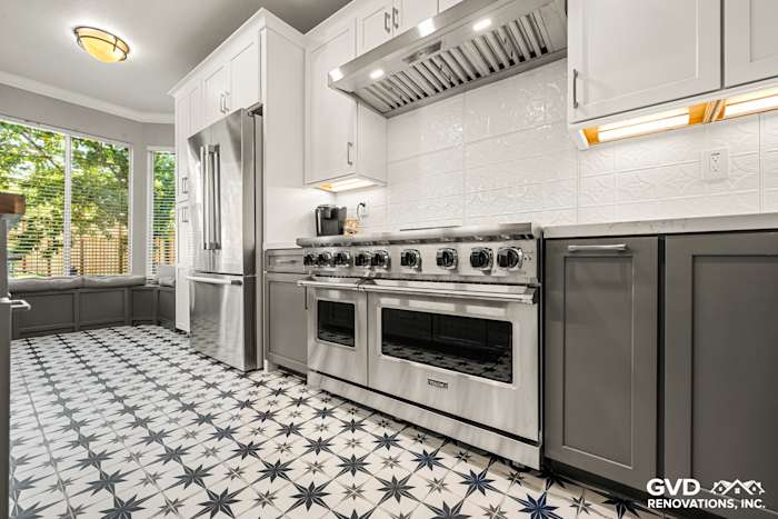 Modern kitchen remodel in Folsom with black and white star-patterned tile, stainless steel appliances, and white cabinetry