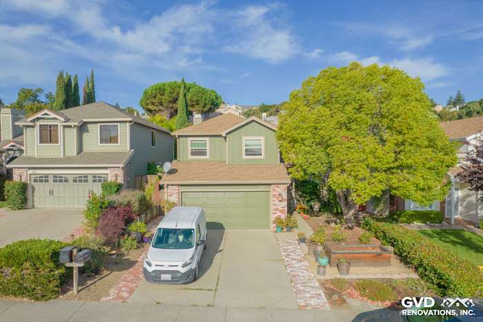 Home exterior featuring Mountain Sage James Hardie siding, gray garage doors, and landscaped yard in Vallejo, CA