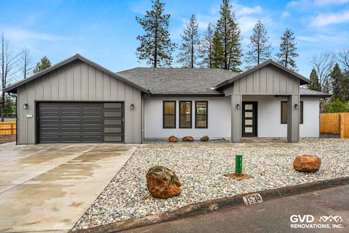 Modern home exterior in Paradise, CA featuring James Hardie panels, Milgard windows, and gravel landscaping