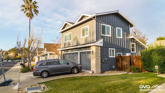 Dublin, CA home featuring newly installed Night Gray James Hardie siding with Arctic White trim and stone accents