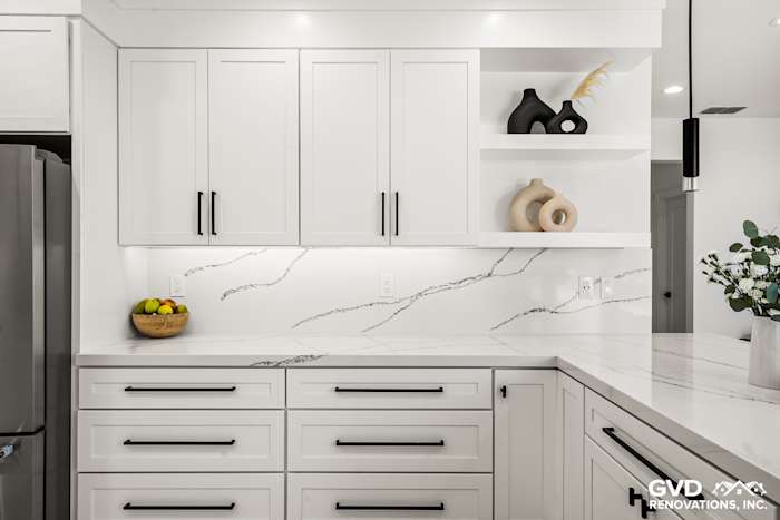 Modern kitchen featuring white quartz countertops, custom cabinets, and minimalist decor in Antelope, CA