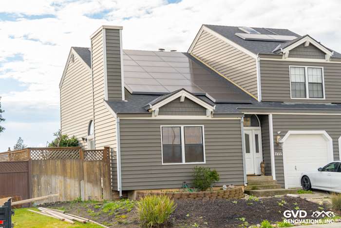 Modern home exterior featuring Prodigy Siding in gray, with solar panels and landscaped lawn in Stockton, CA