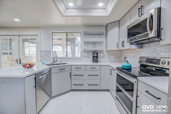 Modern kitchen remodel featuring sleek gray cabinetry, quartz countertops, and mosaic backsplash in Sacramento